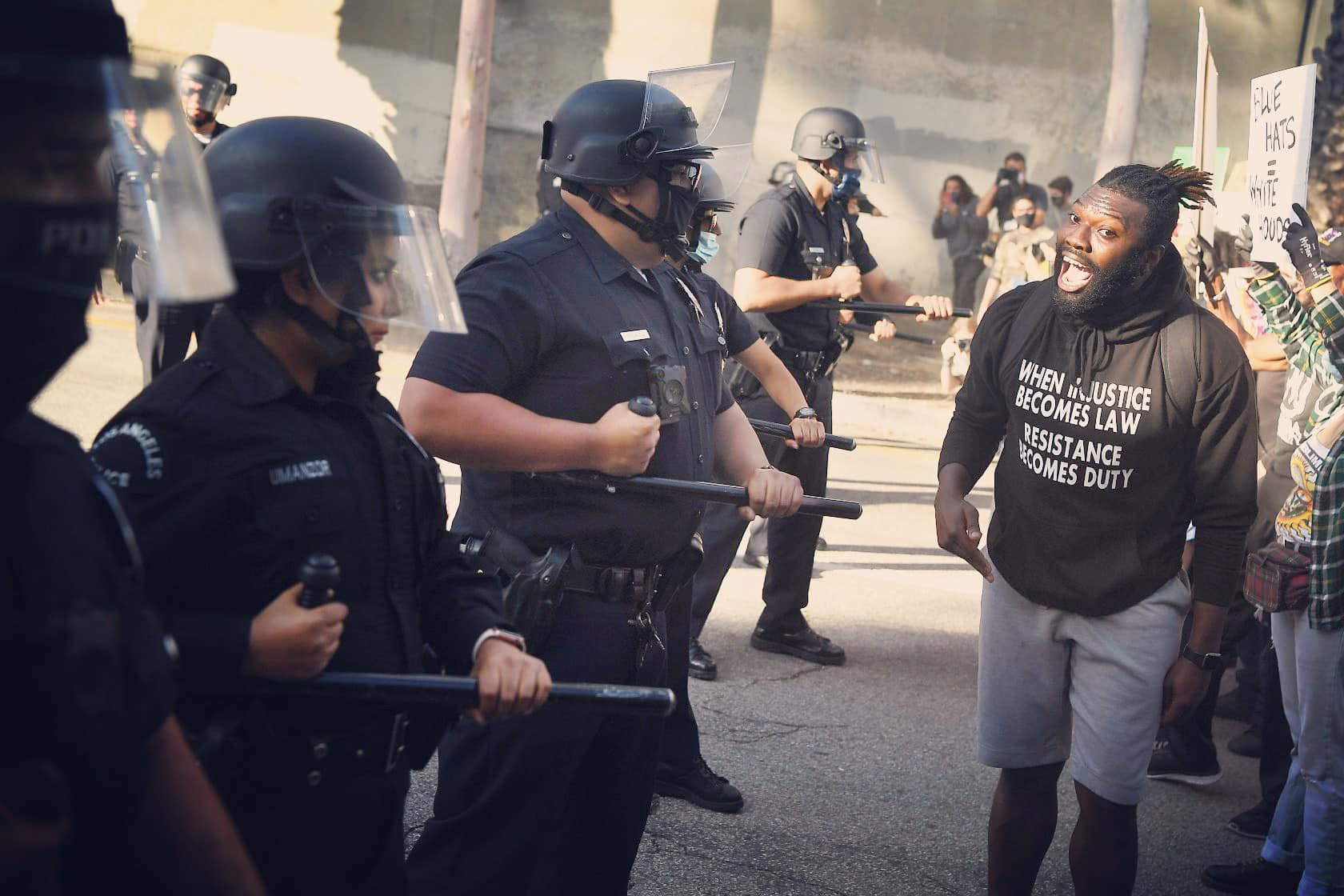 Lawrence face to face with a police line at the 2020 protests in Los Angeles